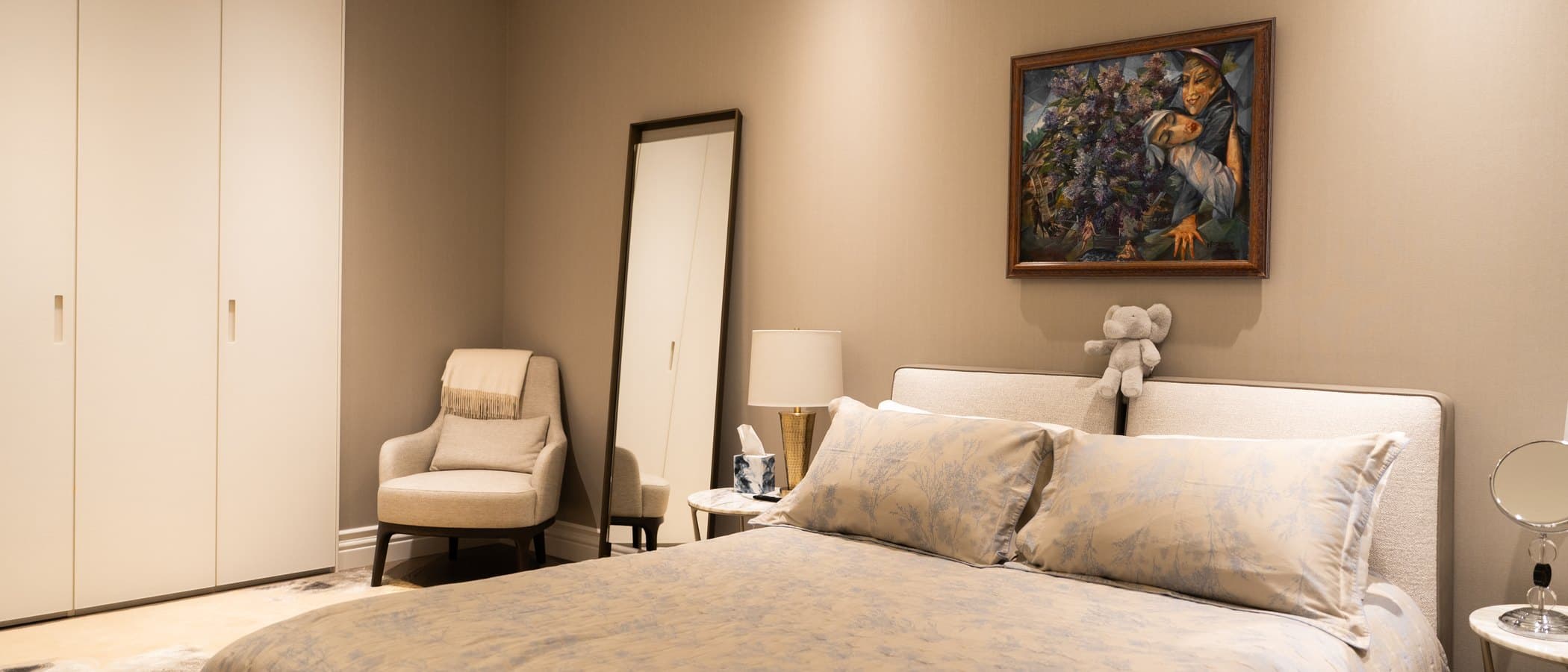 Bedroom with an upholstered bed and fitted wardrobes in a laneway suite