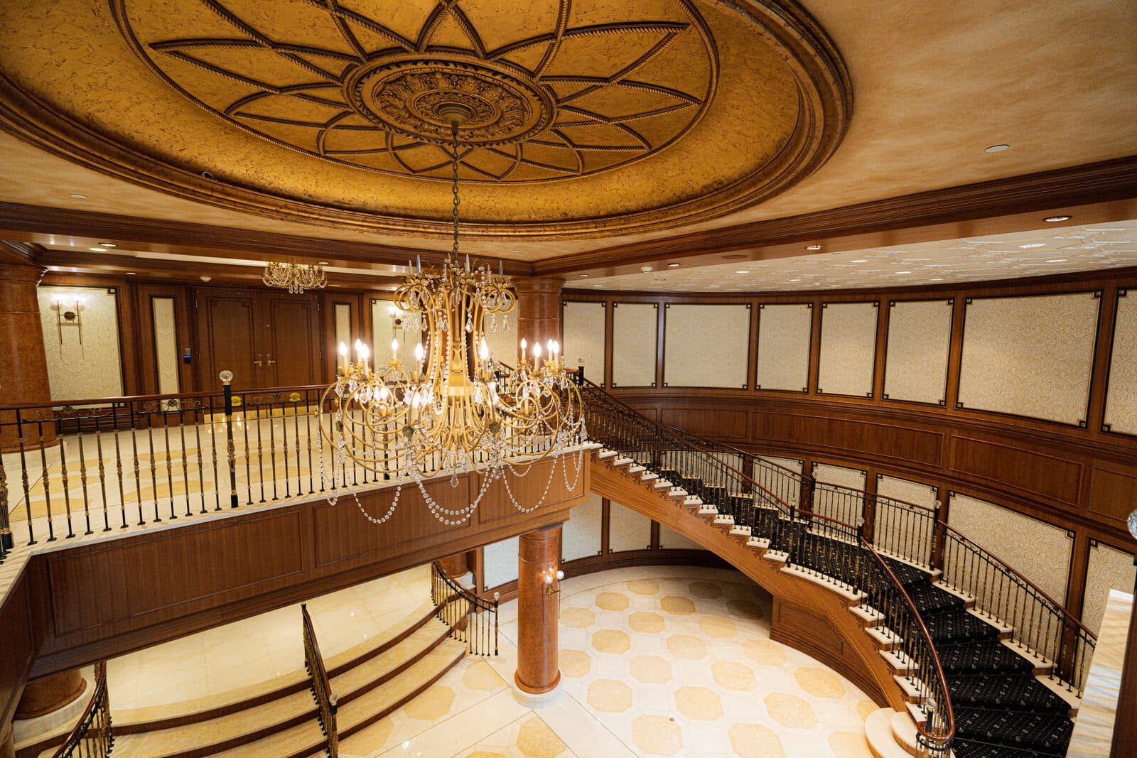 Domed ceiling and chandelier above the lobby stair