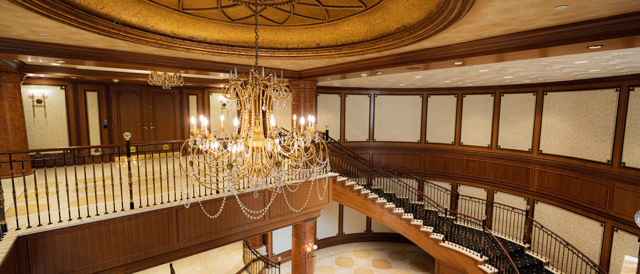 Domed ceiling and chandelier above the lobby stair