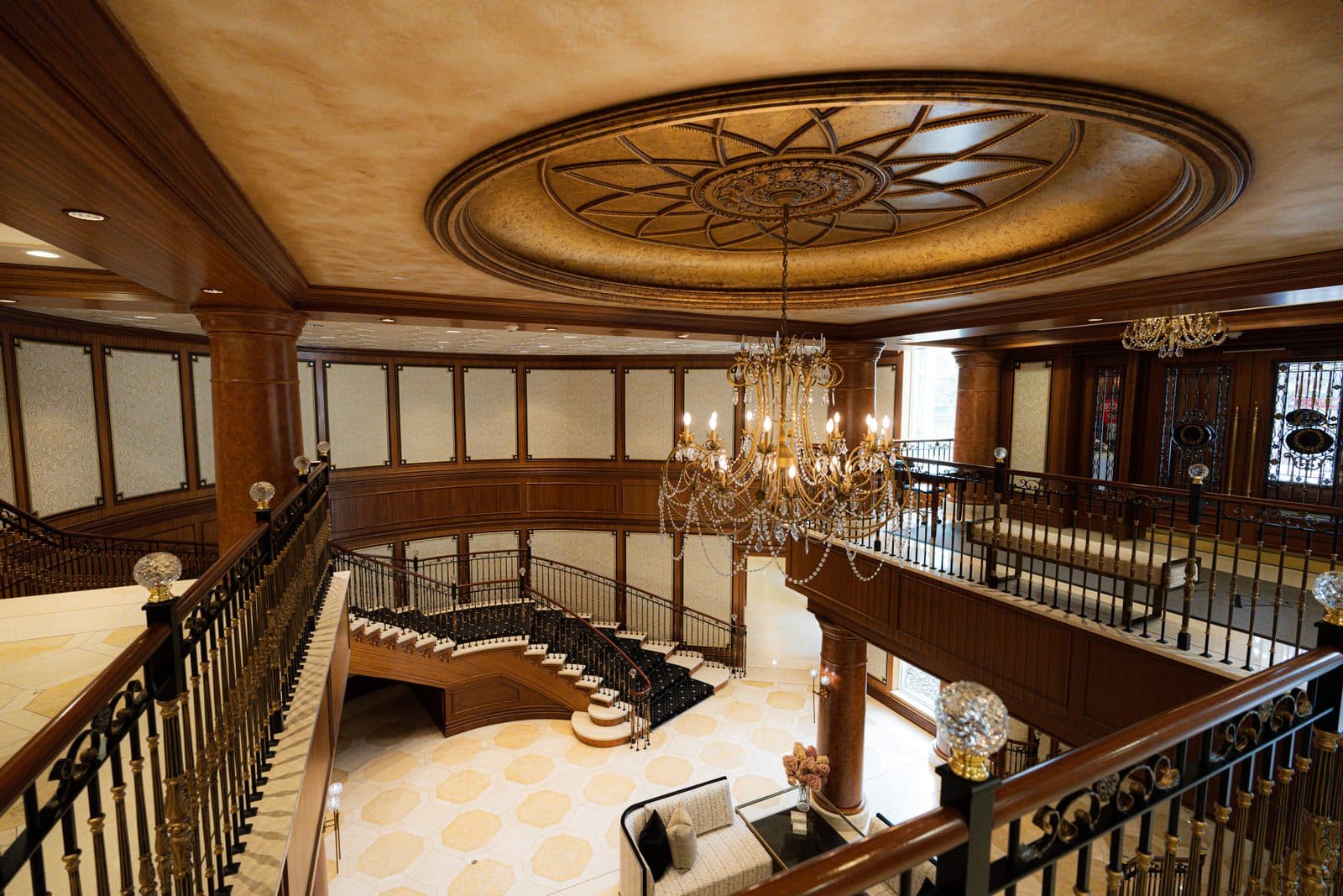 Atrium with a crystal chandelier beneath the gilded dome