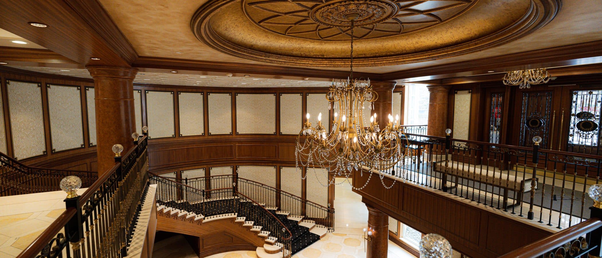 Atrium with a crystal chandelier beneath the gilded dome