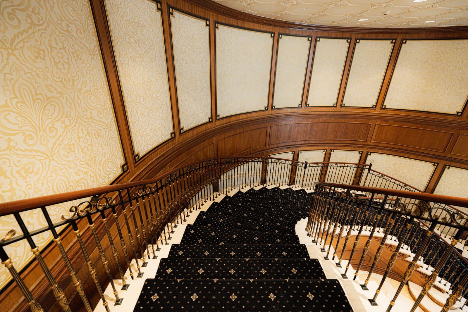 Spiral stair seen down through a wood framed archway