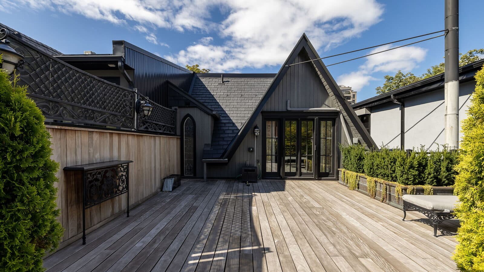 Gothic gable in black slate with a pointed stained glass window