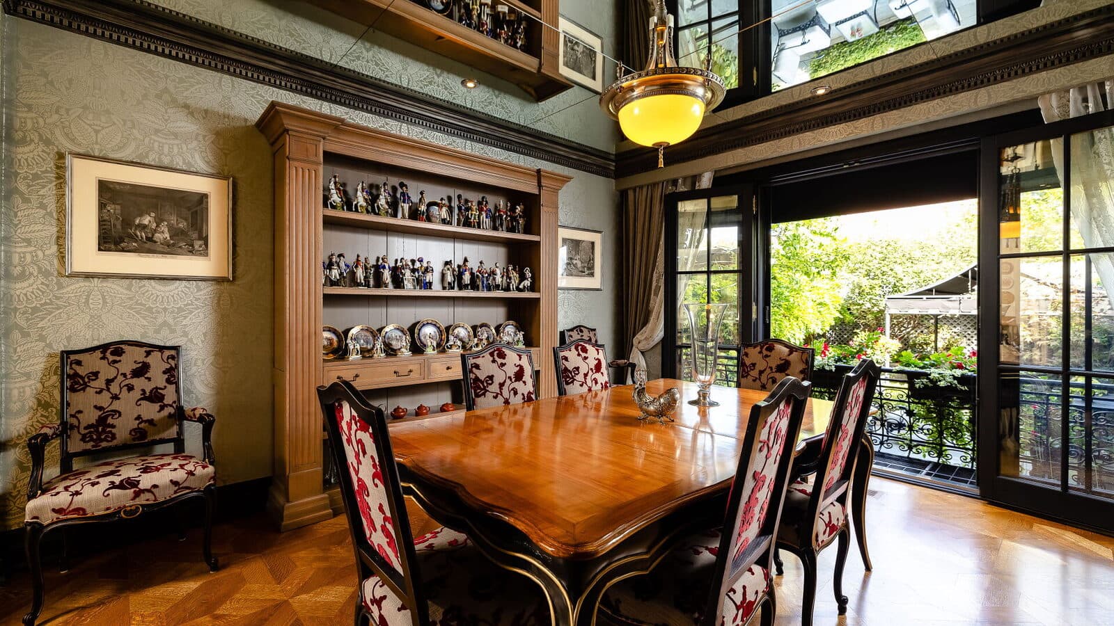 Conservatory dining room with a mirrored ceiling cove and the garden through glass