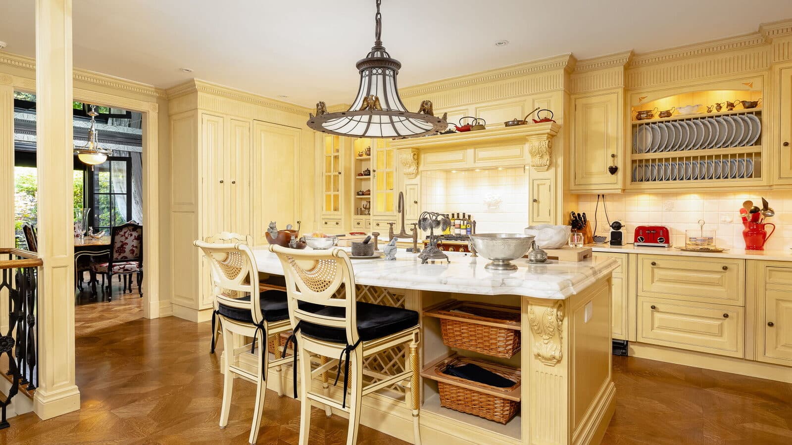 Kitchen island with carved millwork, marble counters and plate racks