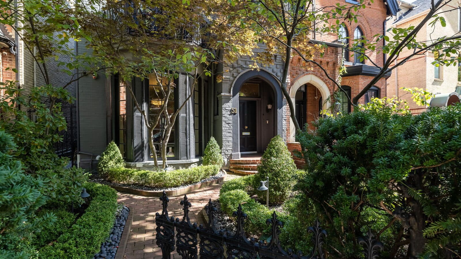 Front garden path and gate beneath a tree canopy