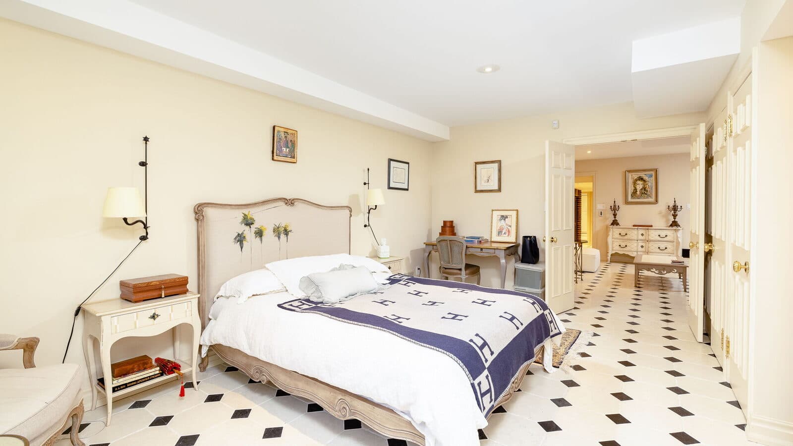 Lower guest suite with a checkerboard floor and a view through to the lounge