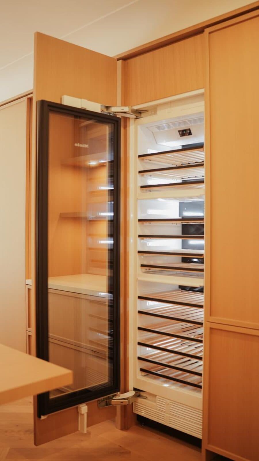 Open wine cabinet built into oak millwork