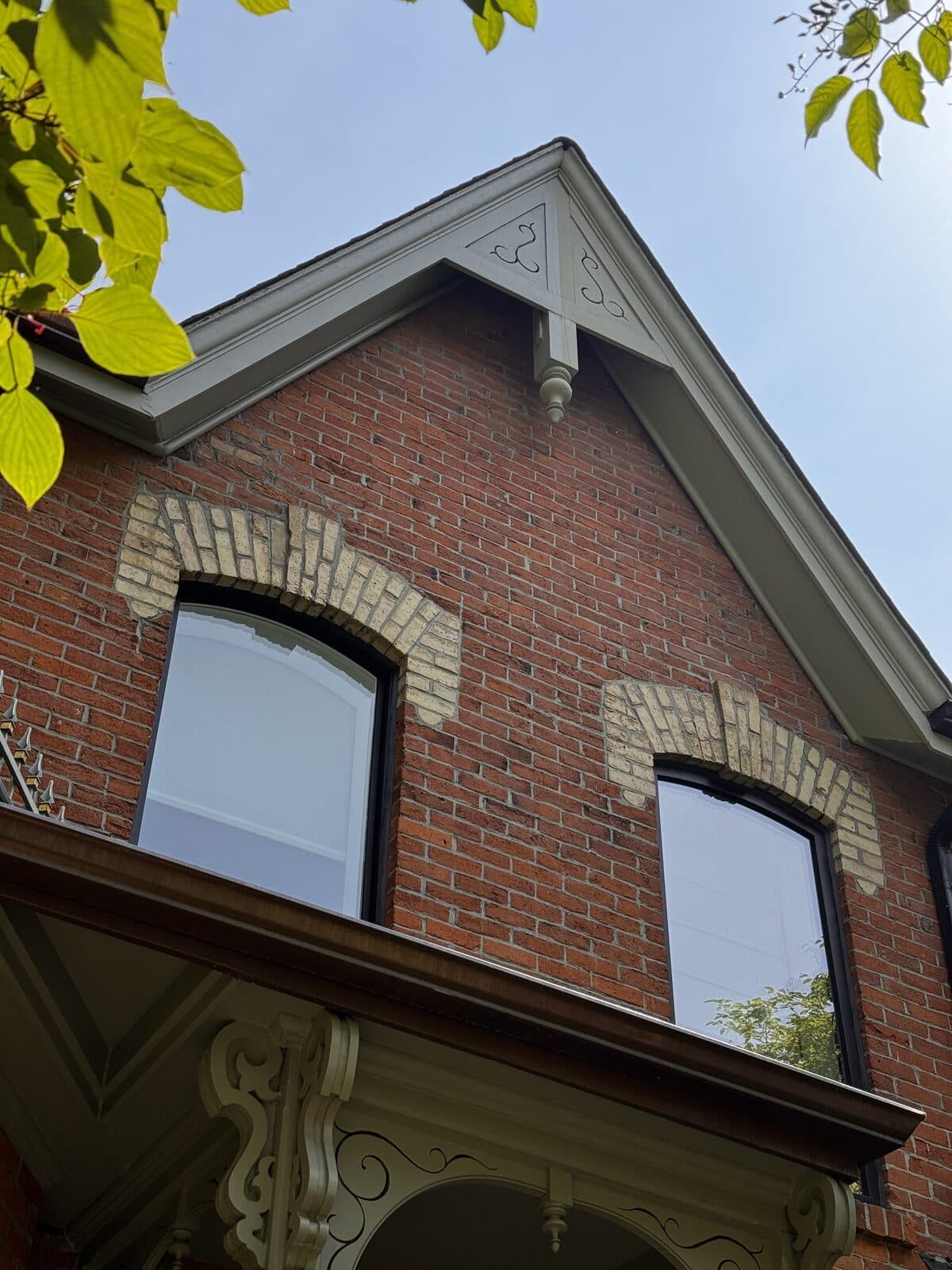 Red brick gable with arched brick voussoirs and cream bargeboard trim