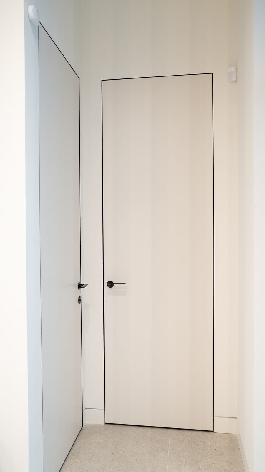 Pair of flush corridor doors with black edge trim