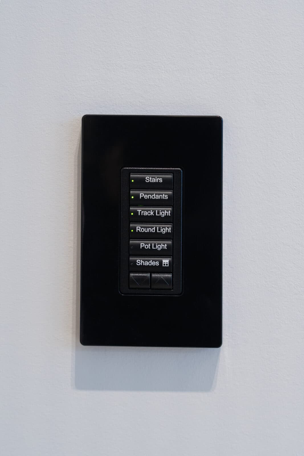 Engraved lighting keypad detail set into the wall