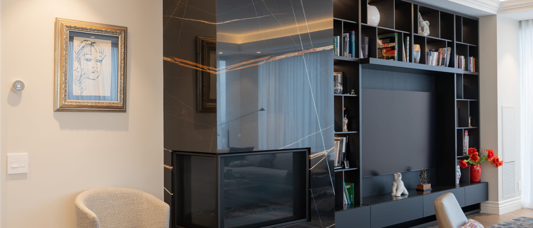 Black marble fireplace and media wall in the living room