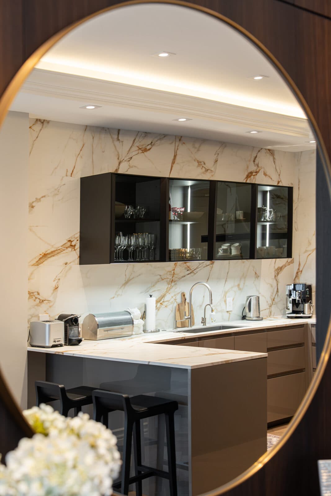 Kitchenette seen reflected in a round brass framed mirror
