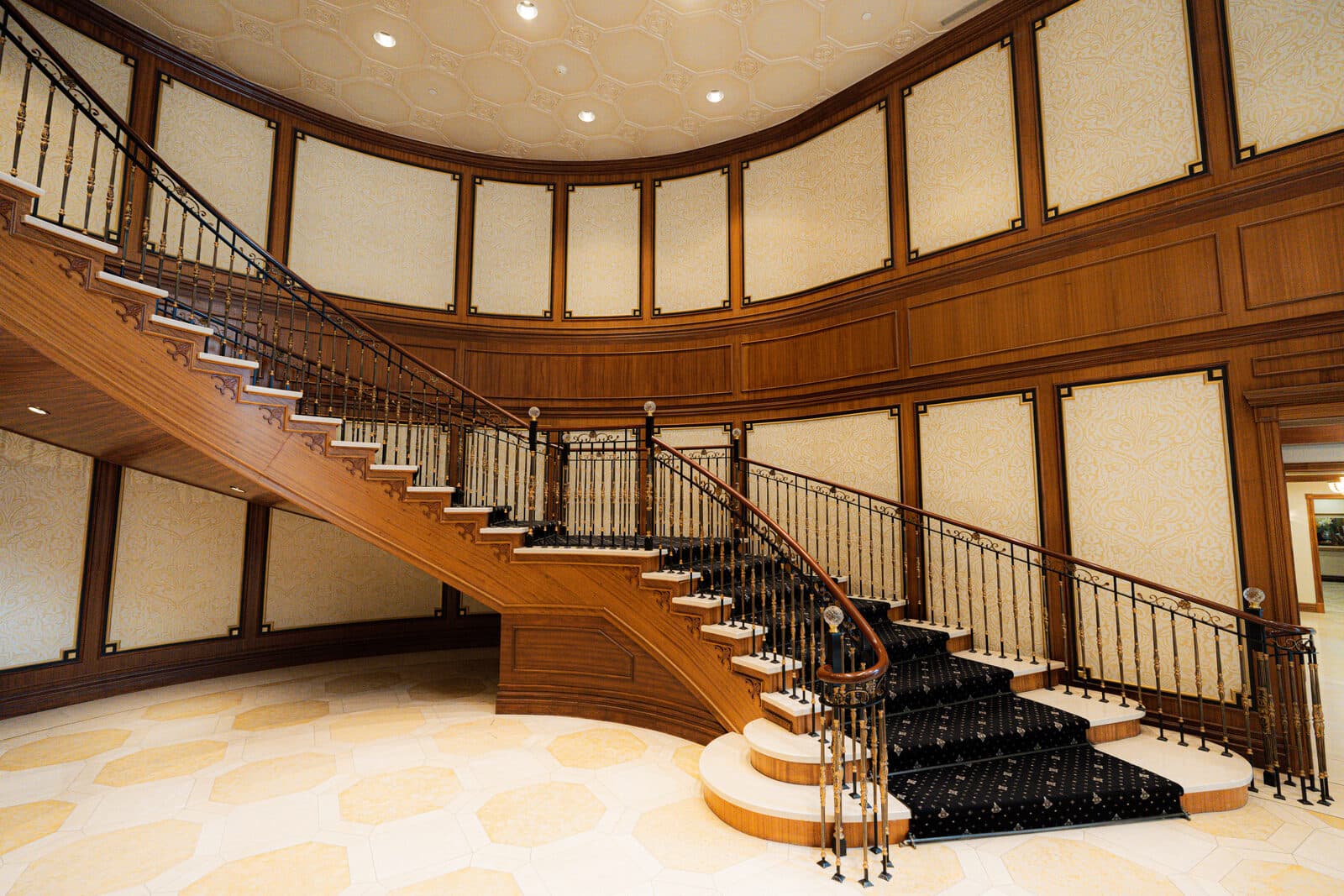 Curved staircase and marble lobby floor from the left of the entry