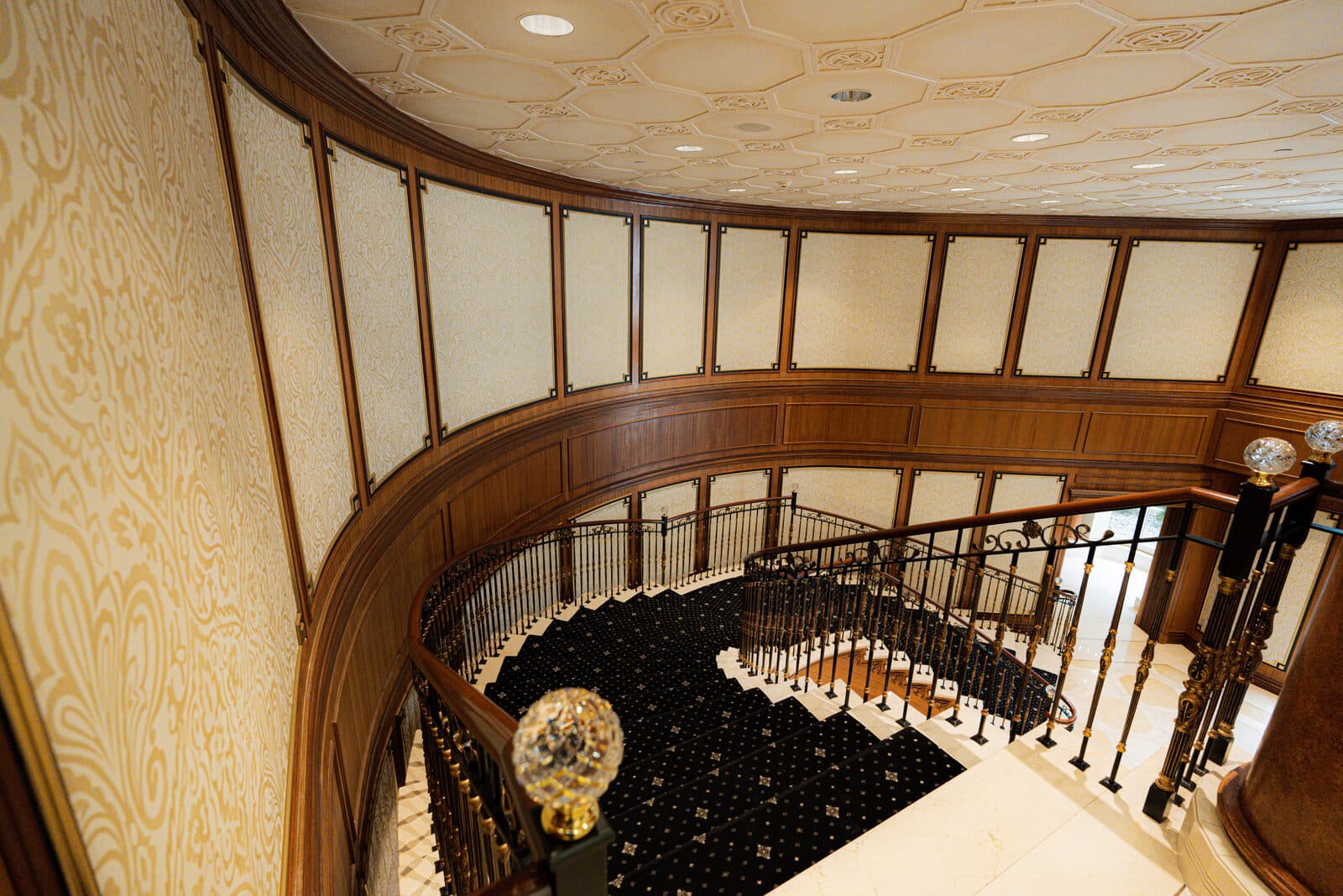View down from the balcony past a faceted crystal globe
