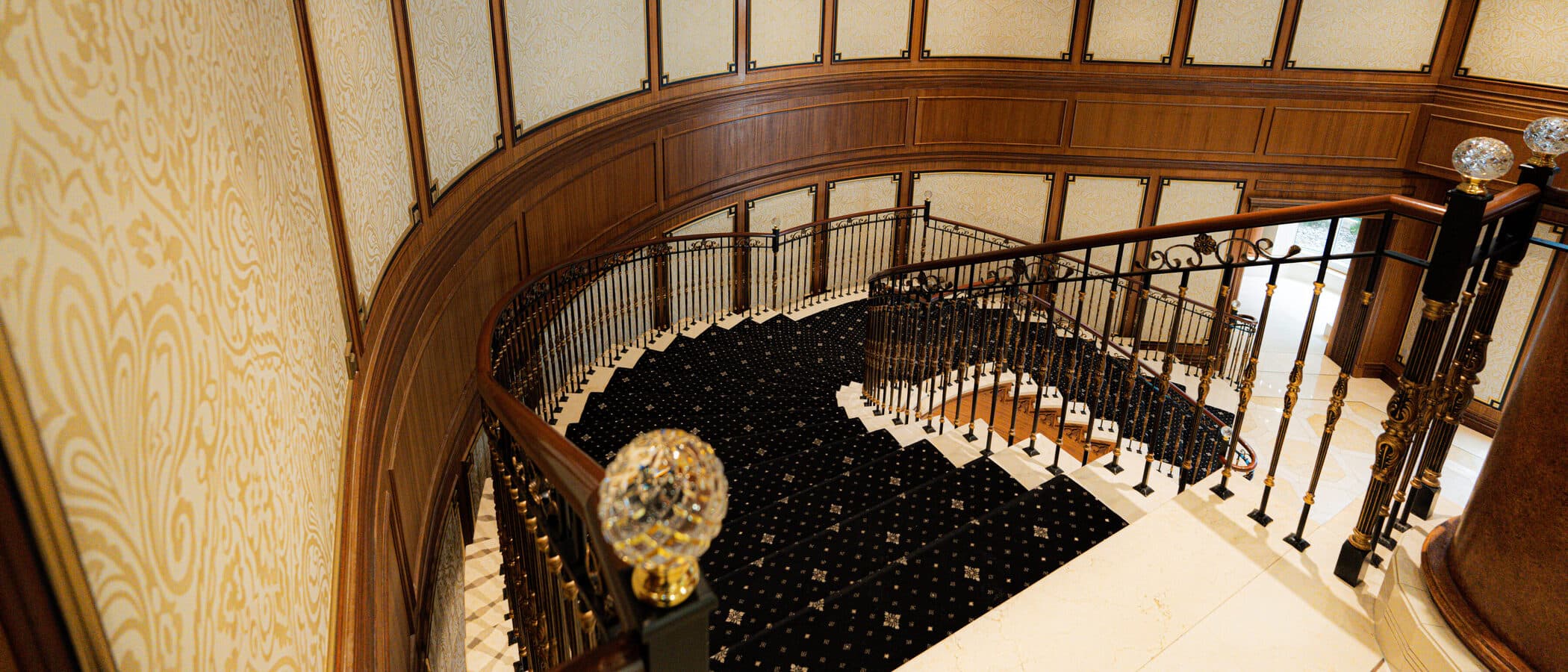 View down from the balcony past a faceted crystal globe