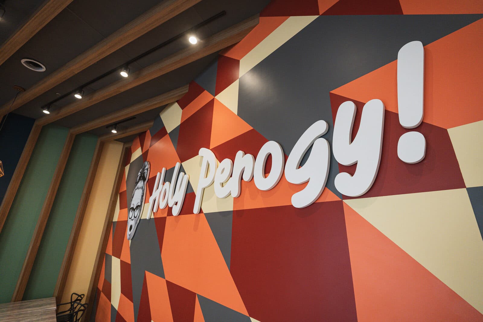 Hand painted geometric mural with the restaurant wordmark