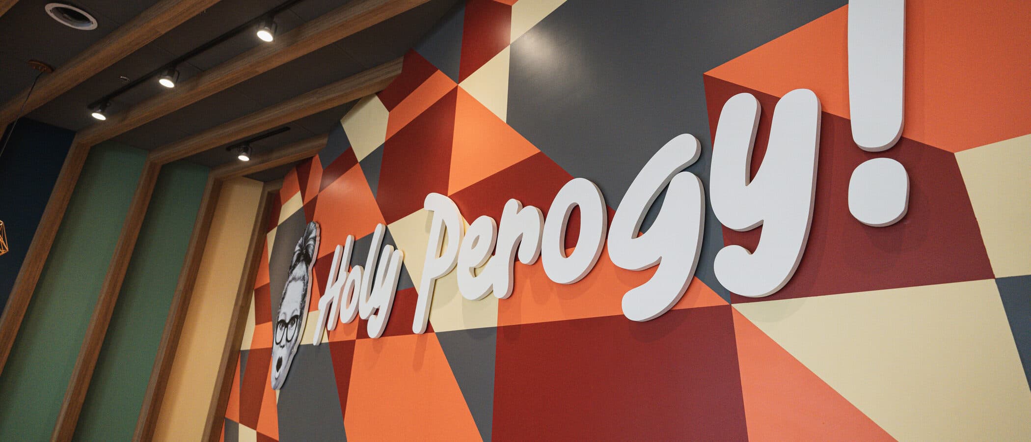Hand painted geometric mural with the restaurant wordmark