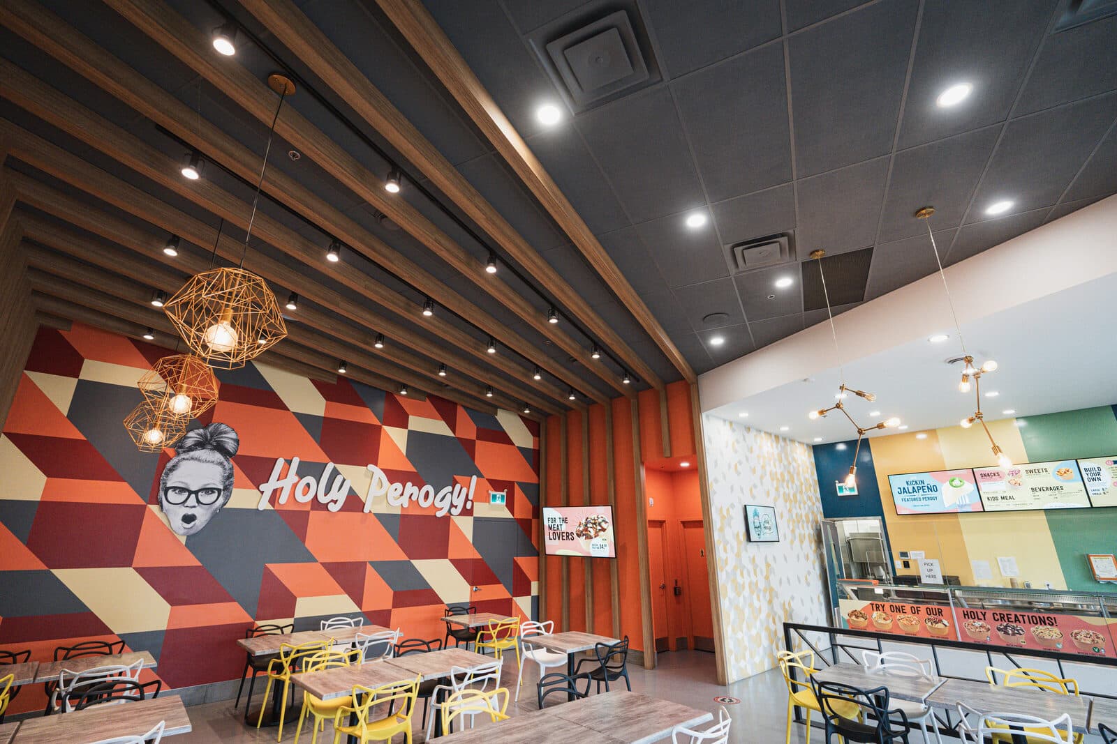 Timber ceiling fins meeting the painted feature wall