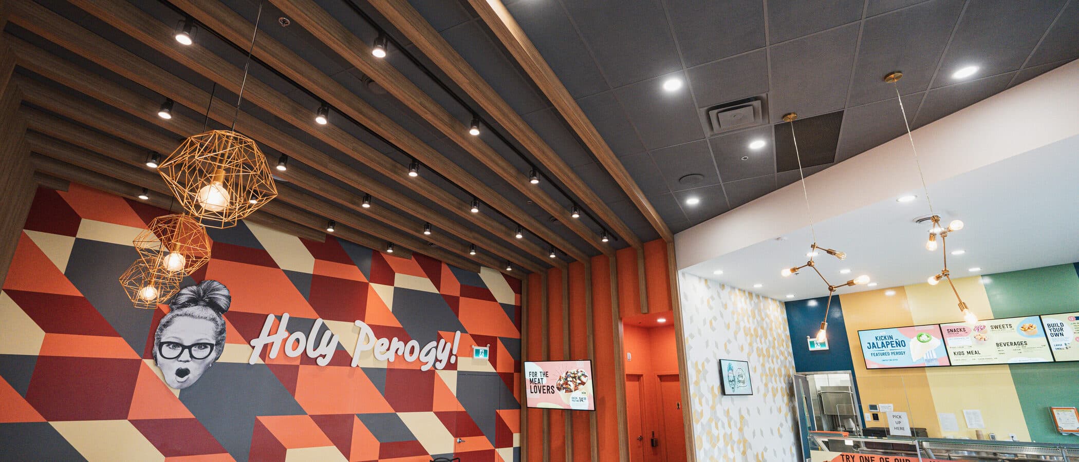 Timber ceiling fins meeting the painted feature wall