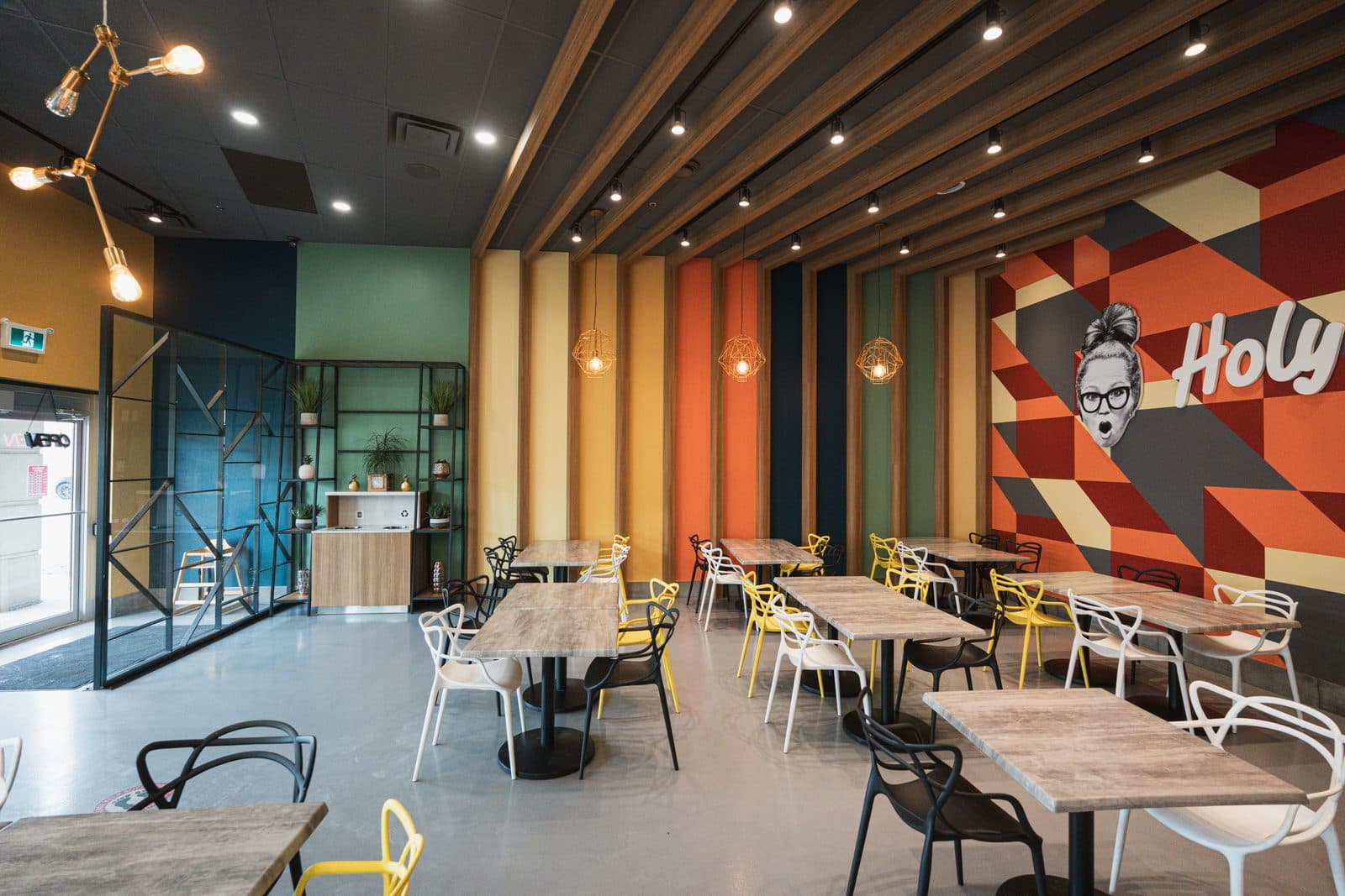 Dining room with coloured wall panels and a plant shelf