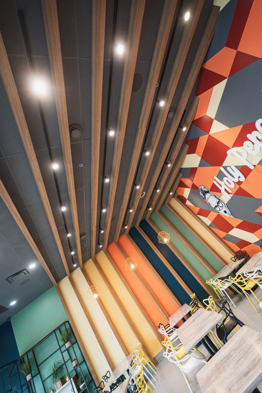 Timber slat ceiling receding toward the painted mural