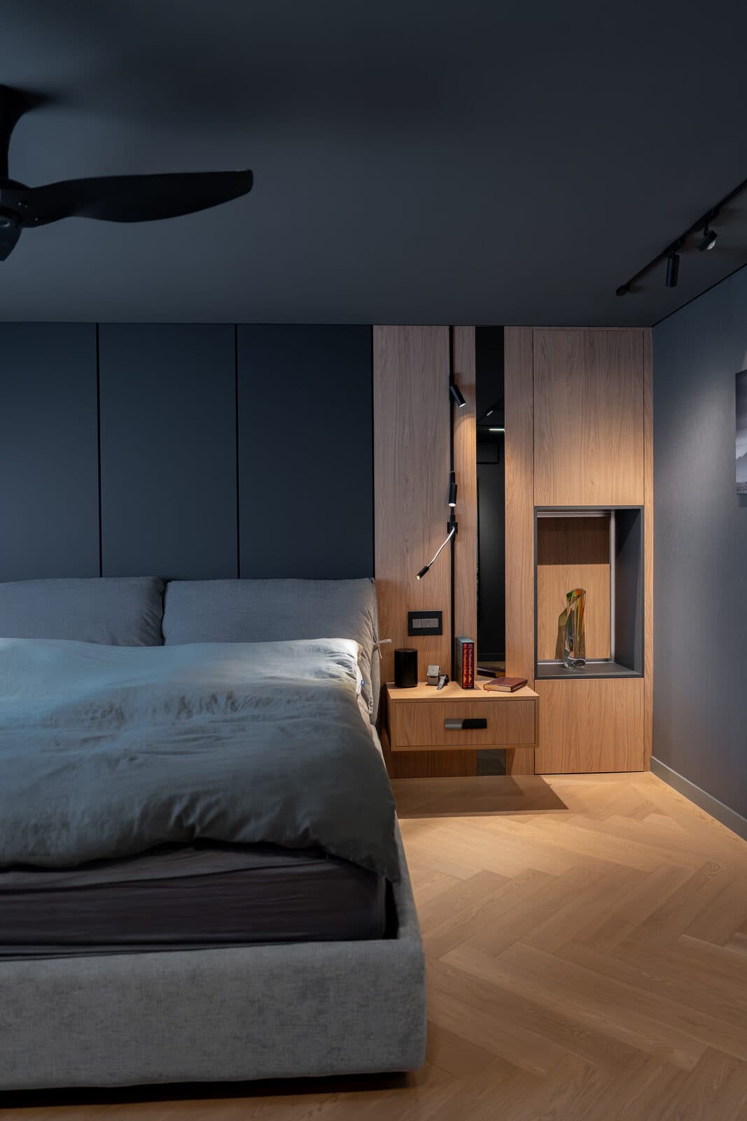 Primary bedroom looking past the bed into an oak dressing nook