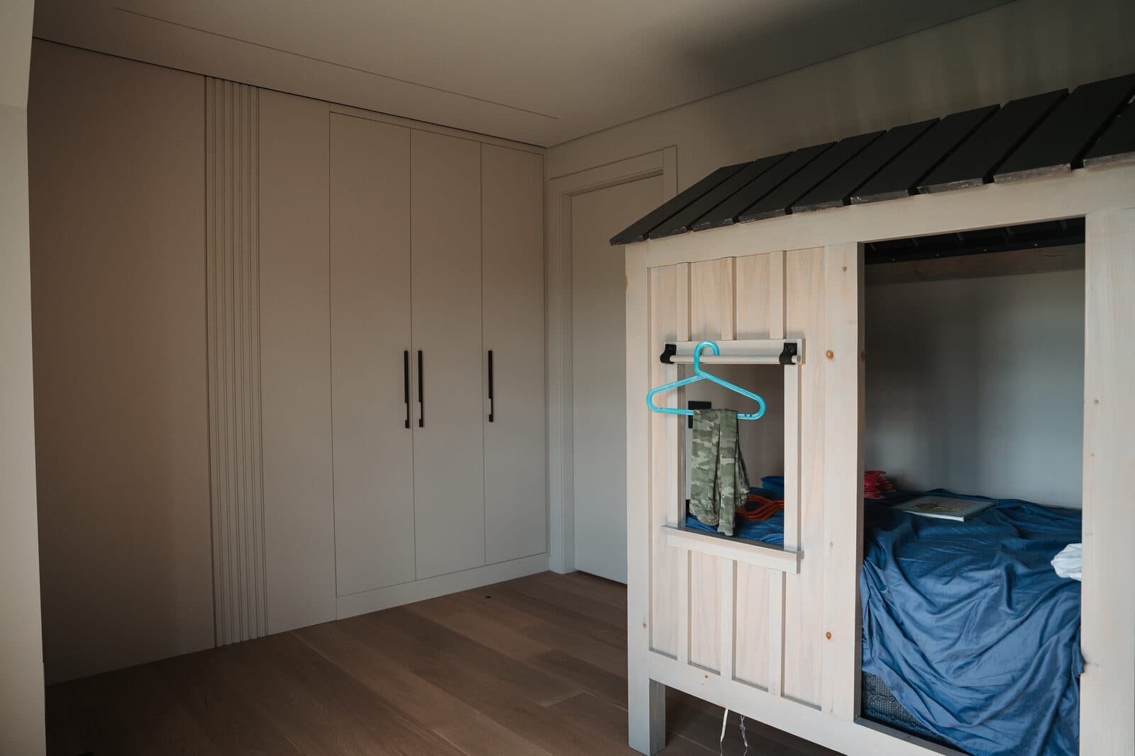 Bedroom with house shaped bed millwork in soft daylight