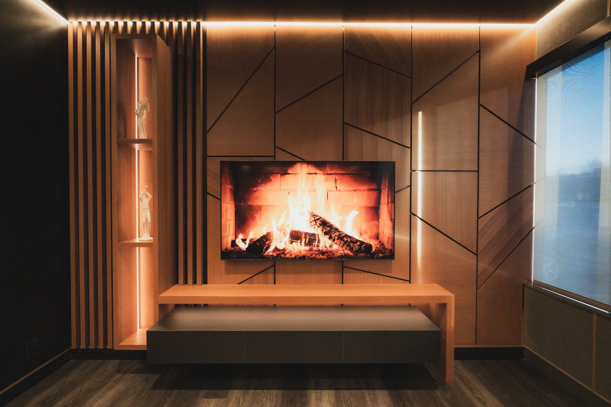 Lounge with a linear fireplace set into a wood panelled wall