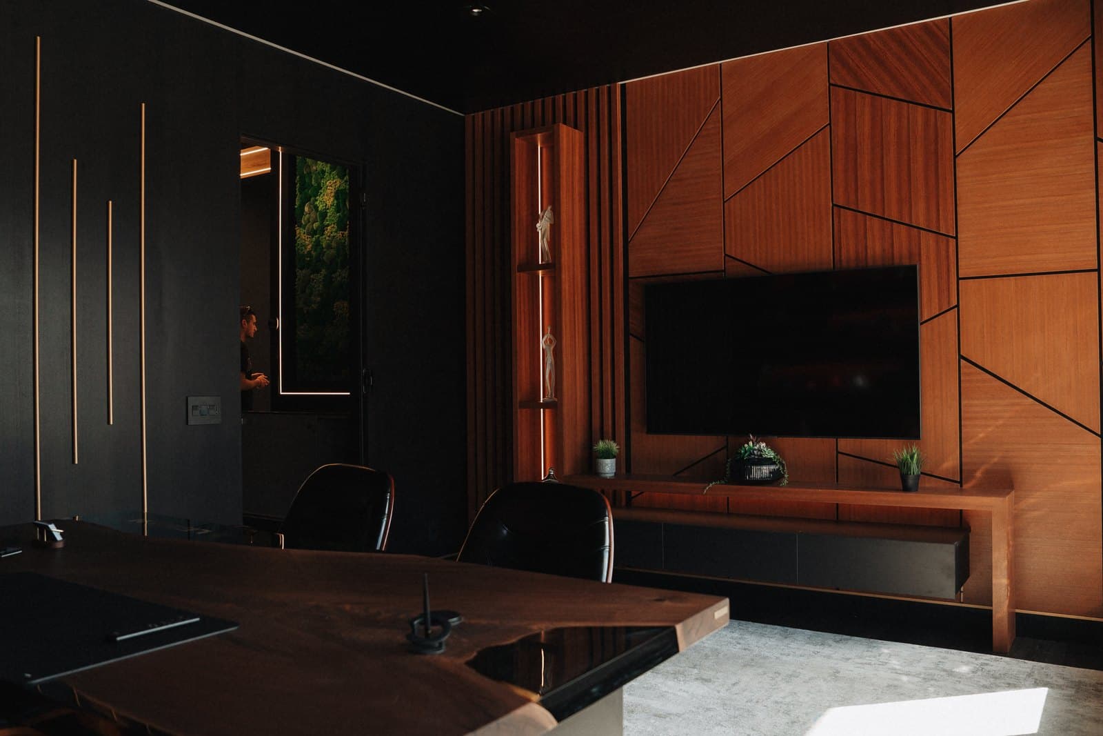 Geometric wood feature wall and display shelving inside the Leman showroom at 5050 Dufferin Street, Toronto