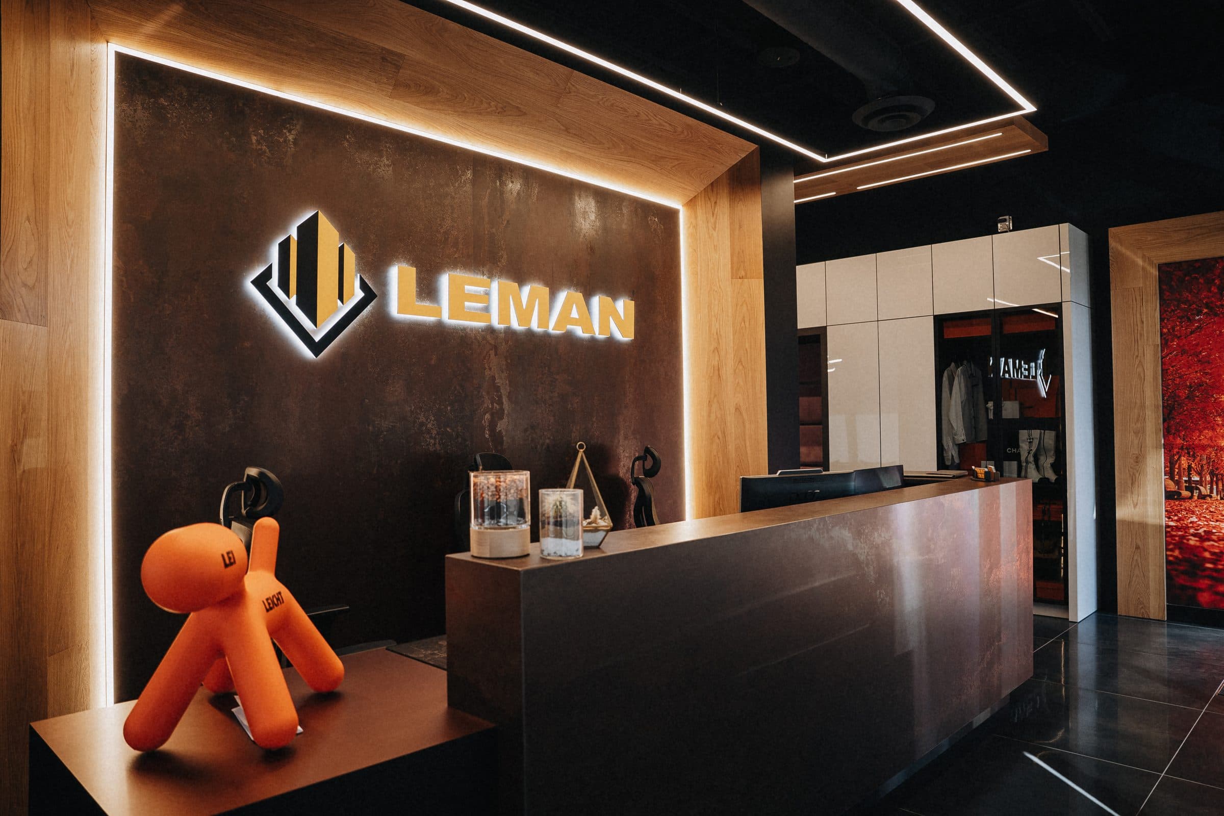 Backlit Leman signage above the showroom reception desk
