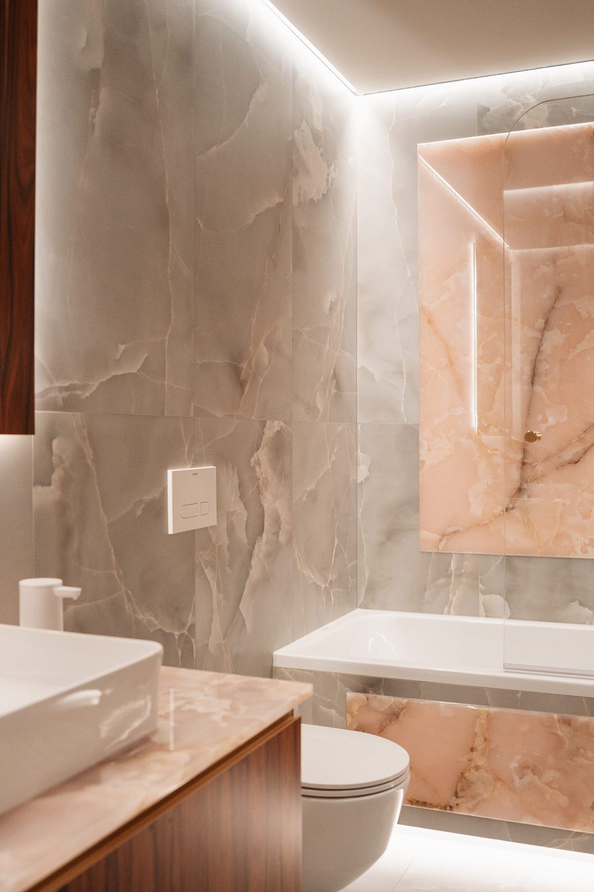Spa bathroom with an onyx feature slab, brass fittings and a freestanding basin